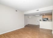 Thumbnail 21 of 49 - A large empty room with wooden floors and white walls.