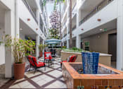Thumbnail 5 of 49 - A courtyard with a fountain and chairs.