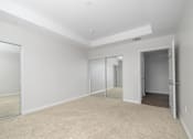 Thumbnail 12 of 49 - A room with white walls and a carpeted floor.