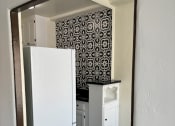 Thumbnail 28 of 35 - a small kitchen with a white refrigerator and a sink