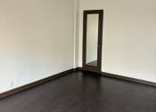 Thumbnail 23 of 35 - an empty living room with wooden floors and a ceiling fan