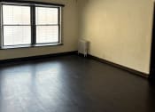 Thumbnail 25 of 35 - an empty living room with a ceiling fan and a window