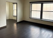 Thumbnail 26 of 35 - an empty living room with wood floors and a window