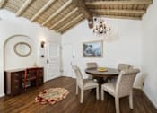 Thumbnail 23 of 27 - Villa Valentino 12 Dining Room with view of the front door and wooden ceiling and hardwood floors