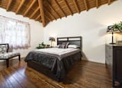 Thumbnail 11 of 27 - Villa Valentino 14 Master Bedroom and large window and wooden ceiling
