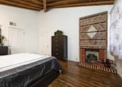 Thumbnail 10 of 27 - Villa Valentino 14 Master Bedroom with a bed facing the brick fireplace