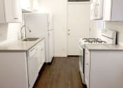 Thumbnail 32 of 38 - a kitchen with white appliances and white cabinets