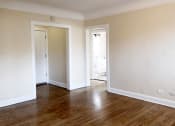 Thumbnail 36 of 38 - a bedroom with hardwood floors and white walls