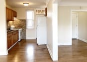 Thumbnail 33 of 38 - a kitchen with a white refrigerator freezer next to a stove top oven