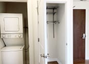 Thumbnail 15 of 23 - a laundry room with a washer and dryer