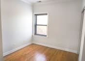 Thumbnail 29 of 48 - a bedroom with white walls and a window