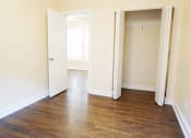 Thumbnail 26 of 38 - a bedroom with hardwood floors and white walls