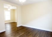 Thumbnail 22 of 38 - a bedroom with hardwood flooring and a window