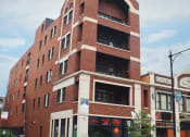 Thumbnail 1 of 23 - a tall red brick building with a rounded top