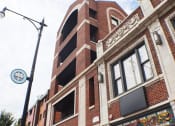 Thumbnail 2 of 23 - a tall brick building with a clock on the side of it