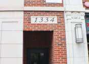Thumbnail 6 of 23 - a brick building with the number 1334 on it