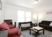 Thumbnail 16 of 38 - a living room with two couches a coffee table and a tv