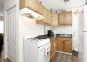 Thumbnail 15 of 38 - a kitchen with wooden cabinets and white appliances