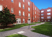 Thumbnail 4 of 38 - a walkway in front of a red brick building