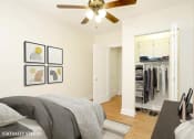 Thumbnail 11 of 38 - a bedroom with a large bed and a ceiling fan