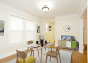 Thumbnail 8 of 38 - a dining room with a table and chairs