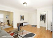 Thumbnail 6 of 38 - a living room with white walls and hardwood floors