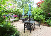 Thumbnail 43 of 48 - a patio with a table and chairs and umbrellas