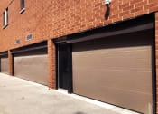 Thumbnail 22 of 23 - a row of three garage doors on a brick building