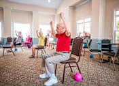 Thumbnail 107 of 109 - A group of elderly people exercising in a room.