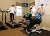 Thumbnail 102 of 109 - Three women exercising in a gym.