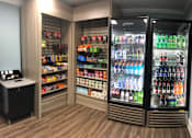 Thumbnail 63 of 109 - A vending machine with a variety of drinks and snacks.