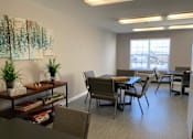 Thumbnail 67 of 109 - A conference room with a long table and chairs, a plant on a table, and a painting on the wall.