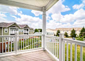 Thumbnail 82 of 109 - A white railing on a wooden deck overlooks a residential neighborhood.
