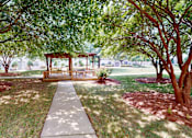 Thumbnail 89 of 109 - A gazebo is surrounded by trees in a park.