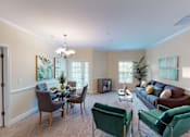 Thumbnail 87 of 109 - A living room with a dining table and chairs.