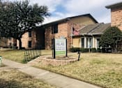 Thumbnail 4 of 7 - a house with an flag on the front of it at Archer Village Apartments, TX, 75092