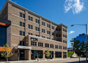 Thumbnail 1 of 10 - A building with the name "FARLEY FLATS" on the front.