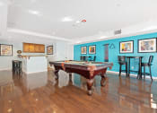 Thumbnail 70 of 74 - a game room with a pool table and bar