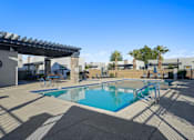 Thumbnail 26 of 36 - A swimming pool with a sun shade over it.