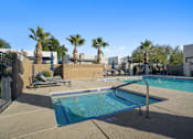 Thumbnail 27 of 36 - A swimming pool surrounded by palm trees and a fence.