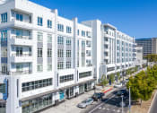Thumbnail 2 of 33 - a large white building with a street in front of it