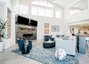 Thumbnail 9 of 17 - Clubroom with seating area, fireplace, and TV at Bridgwater, Colorado, 80111