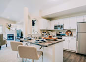 Thumbnail 2 of 17 - Dining area and kitchen with stainless steel appliances at Bridgwater, Greenwood Village, 80111