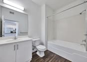 Thumbnail 31 of 40 - A white bathroom with a toilet, sink, and bathtub.