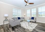 Thumbnail 44 of 60 - a living room with couches and a glass coffee table