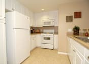 Thumbnail 62 of 80 - Kitchen with white cabinets and appliances