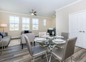 Thumbnail 53 of 60 - a dining room with a glass table and chairs