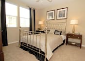 Thumbnail 28 of 80 - Bedroom with night stand and large windows
