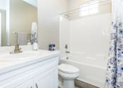 Thumbnail 59 of 60 - a white bathroom with a shower and a sink and a toilet