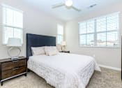 Thumbnail 43 of 60 - a bedroom with a large bed and two windows